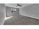 Bedroom featuring a window, ceiling fan, and neutral carpet at 10024 John Adams Way, Orlando, FL 32817