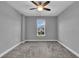 Bedroom with a ceiling fan, and a large window providing view of the outside at 10024 John Adams Way, Orlando, FL 32817