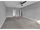 Bedroom featuring carpet, ceiling fan, and attached bathroom and closet at 10024 John Adams Way, Orlando, FL 32817