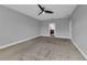 Bedroom featuring carpet, ceiling fan, and attached bathroom at 10024 John Adams Way, Orlando, FL 32817