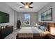 Cozy bedroom featuring a ceiling fan, a large window and stylish furniture with lamps at 10024 John Adams Way, Orlando, FL 32817