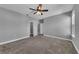 Bedroom featuring a ceiling fan, closet, gray walls and plush carpet at 10024 John Adams Way, Orlando, FL 32817