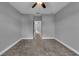 Empty bedroom with a ceiling fan, carpet floors, white trim and neutral walls at 10024 John Adams Way, Orlando, FL 32817