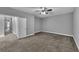 Bedroom with neutral walls, plush carpeting, and a modern ceiling fan at 10024 John Adams Way, Orlando, FL 32817