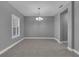 Bright dining room featuring tile flooring, a modern light fixture, and a window with plantation shutters at 10024 John Adams Way, Orlando, FL 32817