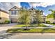 Desirable property showcasing dual attached garages, mature trees, and manicured landscaping at 10024 John Adams Way, Orlando, FL 32817