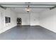 A clean, empty garage with a sealed floor, water heater, and bright lighting at 10024 John Adams Way, Orlando, FL 32817