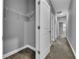 This is a hallway with multiple doors, an air vent, and carpeted floors that provides access to other rooms at 10024 John Adams Way, Orlando, FL 32817