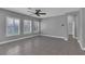 Spacious living room with gray paint, tile flooring, and bright windows at 10024 John Adams Way, Orlando, FL 32817