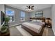 This is a spacious main bedroom that is decorated with a ceiling fan, lamps, and artwork at 10024 John Adams Way, Orlando, FL 32817