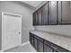 Pantry with granite countertops and dark wood cabinets, offering ample storage at 10024 John Adams Way, Orlando, FL 32817