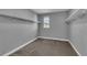 Empty walk-in closet featuring carpet flooring, white trim and racks, and window at 10024 John Adams Way, Orlando, FL 32817