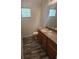 Bathroom with wood-look vinyl flooring, wood vanity, and framed mirror at 1004 Travertine Ter, Sanford, FL 32771