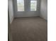 Large bedroom with new carpet flooring and natural light from the windows at 1004 Travertine Ter, Sanford, FL 32771