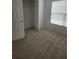 Bedroom featuring a closet, window, and neutral carpet, offering a serene and functional space at 1004 Travertine Ter, Sanford, FL 32771