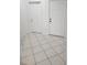 Tiled entryway with two white doors and baseboard trim at 1004 Travertine Ter, Sanford, FL 32771