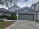 Charming two-story home featuring a well-manicured lawn and a neutral gray color scheme at 1004 Travertine Ter, Sanford, FL 32771