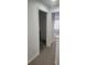 Bright hallway featuring neutral carpet flooring and doors to other rooms in the home at 1004 Travertine Ter, Sanford, FL 32771