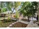 Serene backyard featuring a dining set, lush greenery, and a charming pergola at 10809 Oak Glen Cir, Orlando, FL 32817