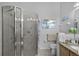 Bright bathroom with a modern glass shower and neutral tiling, plus coastal-themed decor at 10809 Oak Glen Cir, Orlando, FL 32817