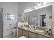 Dual sink bathroom with granite countertop, and a glass-enclosed shower at 10809 Oak Glen Cir, Orlando, FL 32817