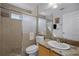 Bathroom with a tiled shower, granite countertop vanity, and stylish fixtures at 10809 Oak Glen Cir, Orlando, FL 32817