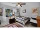 Comfortable bedroom with a window, ceiling fan, and tiled floors, creating a relaxing atmosphere at 10809 Oak Glen Cir, Orlando, FL 32817