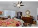 This bedroom features a ceiling fan, closet, and natural light to create a serene and comfortable atmosphere at 10809 Oak Glen Cir, Orlando, FL 32817