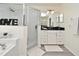 Modern bathroom featuring a sleek, glass-enclosed shower, double sink vanity, and a large mirror at 1215 Castleport Rd, Winter Garden, FL 34787