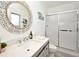 Bathroom with a gray vanity, a modern sink, a decorative mirror, and a shower with sliding glass doors at 1215 Castleport Rd, Winter Garden, FL 34787