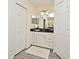 Spacious bathroom featuring a granite countertop vanity, closet and tile floors at 1215 Castleport Rd, Winter Garden, FL 34787