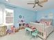 Bright bedroom with light blue walls, a ceiling fan and pink bedding at 1215 Castleport Rd, Winter Garden, FL 34787