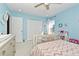 Light blue bedroom with white trim featuring a ceiling fan, closet and window at 1215 Castleport Rd, Winter Garden, FL 34787