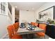 Dining room with orange upholstered chairs, modern art, and light wood-look floors at 1215 Castleport Rd, Winter Garden, FL 34787