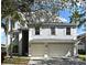 Two-story home with an attached two-car garage, pale blue paint, and white trim at 1215 Castleport Rd, Winter Garden, FL 34787