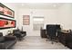 Home office featuring modern decor, black leather chairs, a window and light wood-look flooring at 1215 Castleport Rd, Winter Garden, FL 34787