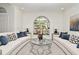 Living room with an arch window, two curved sofas, a glass table, and modern decor at 1215 Castleport Rd, Winter Garden, FL 34787