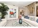 Living room with a white sofa, modern art, a staircase, and gray wood-look floors at 1215 Castleport Rd, Winter Garden, FL 34787