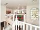 Bright loft with white railing overlooking lower floor and a large window at 1215 Castleport Rd, Winter Garden, FL 34787