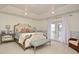 Spacious main bedroom with tray ceiling, plush carpet, and French doors to outdoor balcony at 1215 Castleport Rd, Winter Garden, FL 34787