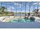 The screened in pool area offers a lovely view of the lake and the property's lush landscaping at 1215 Castleport Rd, Winter Garden, FL 34787