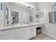 Well-lit bathroom with a long countertop, ample cabinet space, and a large mirror over the sink area at 13500 Turtle Marsh Loop # 816, Orlando, FL 32837