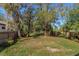 Large backyard with mature trees and wood fence at 1518 Fabian Ave, Orlando, FL 32807