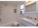 Bathroom with a tub, a shower, subway tile, a decorative mirror, and a single sink at 1518 Fabian Ave, Orlando, FL 32807