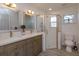 Bathroom featuring dual sinks, a corner shower with glass door, and tile floors at 1518 Fabian Ave, Orlando, FL 32807