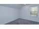 Empty bedroom with carpeted floors and a window providing natural light at 1518 Fabian Ave, Orlando, FL 32807