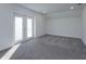 An empty bedroom with carpeted floors and a glass door to an outdoor balcony at 1518 Fabian Ave, Orlando, FL 32807