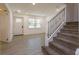 Bright foyer with tile flooring, staircase with iron railing, and front door at 1518 Fabian Ave, Orlando, FL 32807