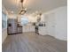 Bright kitchen featuring stainless steel appliances, white cabinets, and wood-look tile floors at 1518 Fabian Ave, Orlando, FL 32807