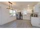 Bright kitchen with stainless steel appliances, white cabinetry, and stylish light fixture at 1518 Fabian Ave, Orlando, FL 32807